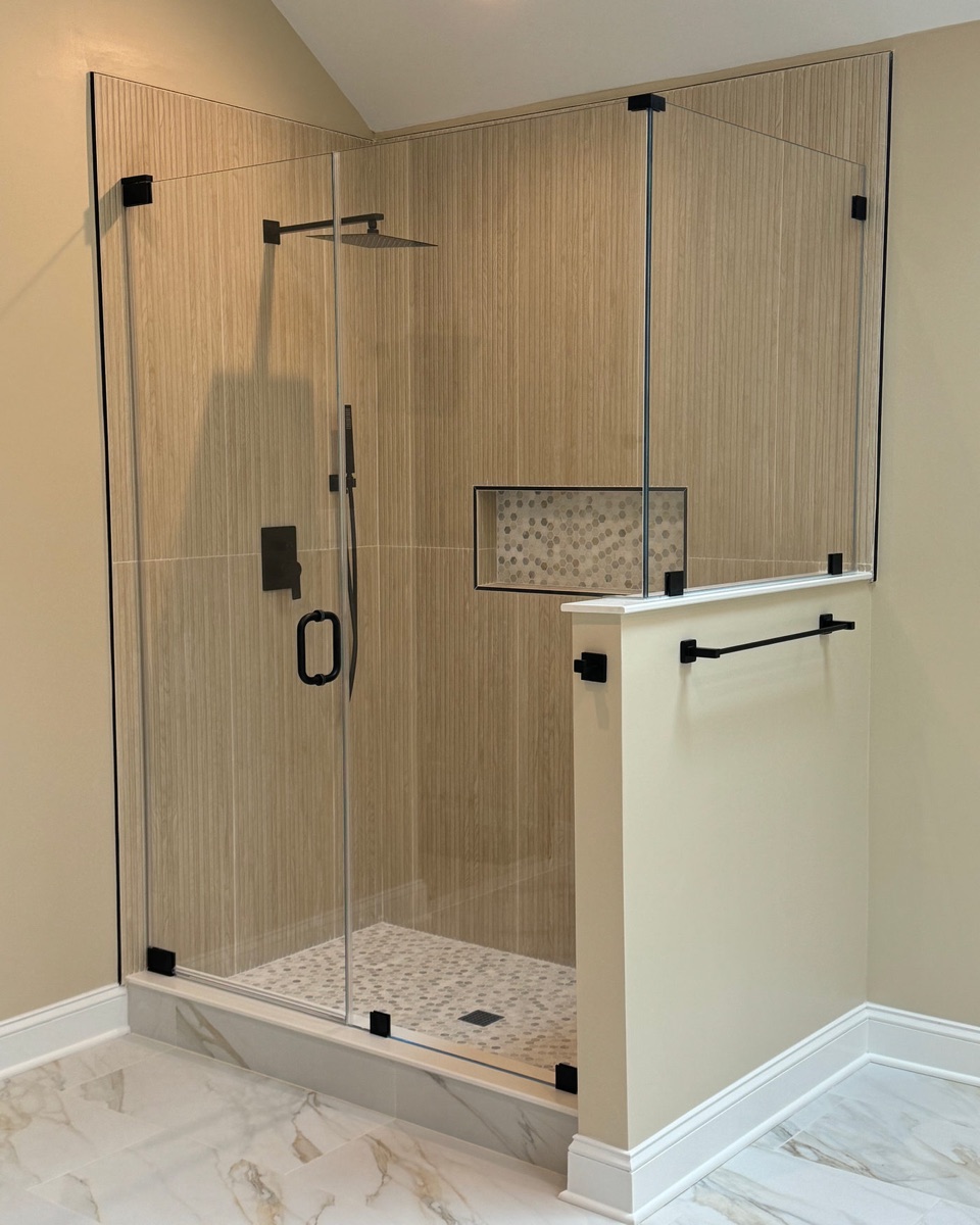 Breakwater Series frameless hinged corner shower door with matte black hardware, installed in Maryland