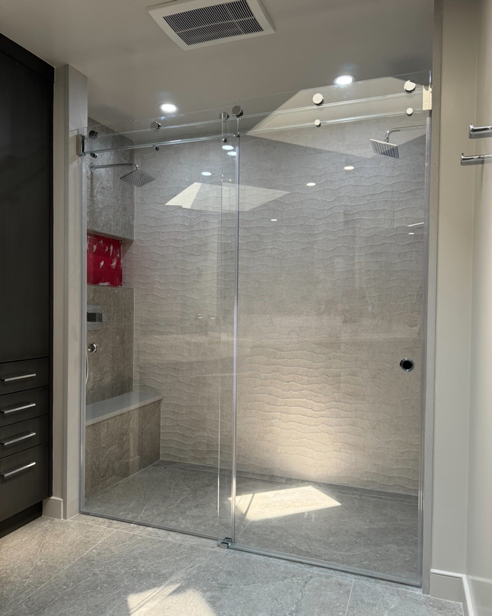 Glasswave Series all-glass sliding shower system with glass header, custom installed in Maryland