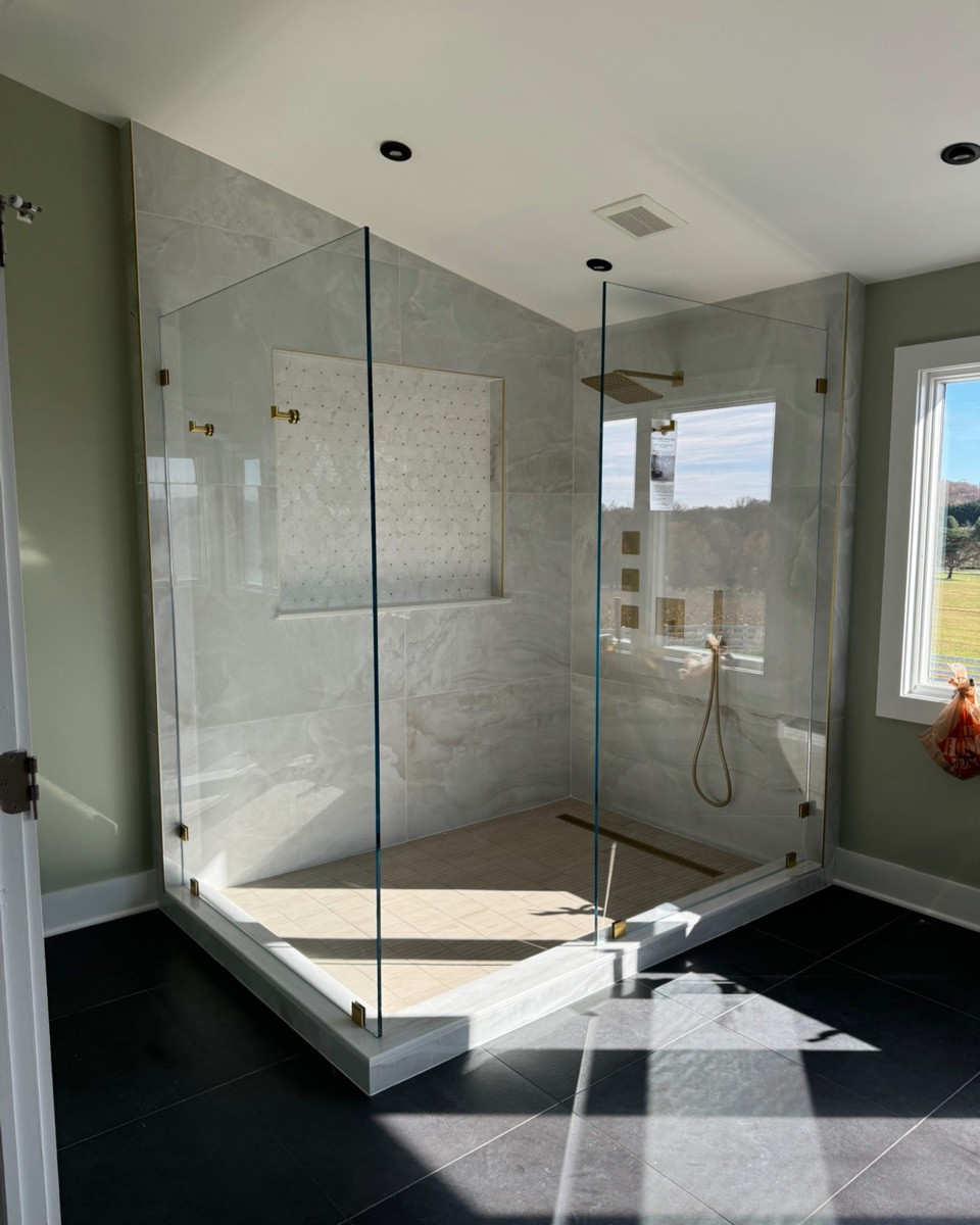 Large 90-degree frameless glass shower enclosure with low-iron glass in a Maryland master bathroom
